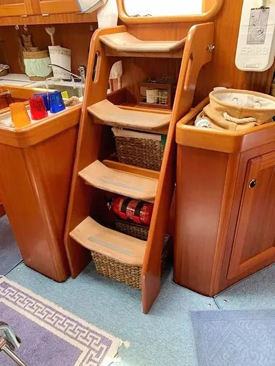  Yacht Photos Pics Wooden interior stairs on a 2006 Hallberg-Rassy 48 MK yacht with storage baskets.