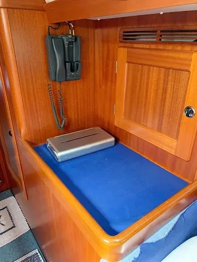  Yacht Photos Pics 2006 Hallberg-Rassy 48 MK interior with wooden cabinetry and communication equipment.