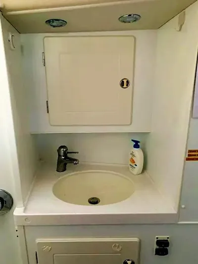  Yacht Photos Pics Hallberg-Rassy 48 MK 2006 yacht bathroom sink with cabinet and soap dispenser.