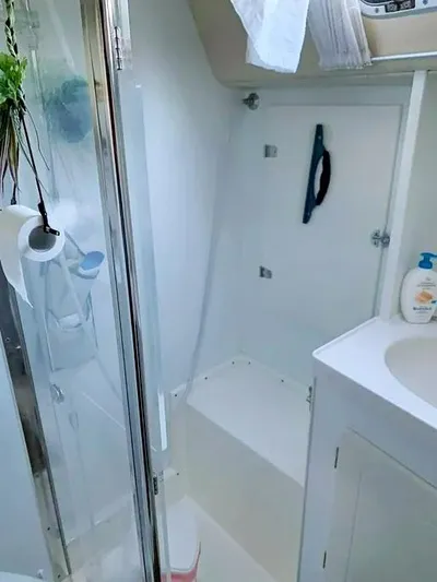  Yacht Photos Pics Bathroom interior of 2006 Hallberg-Rassy 48 MK yacht, featuring shower and sink.