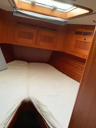  Yacht Photos Pics Interior cabin of 2006 Hallberg-Rassy 48 MK sailboat with wooden finish and skylight.