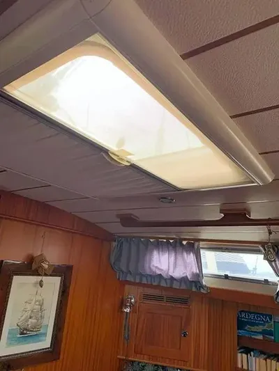  Yacht Photos Pics Interior of 2006 Hallberg-Rassy 48 MK yacht with wooden paneling and skylight.