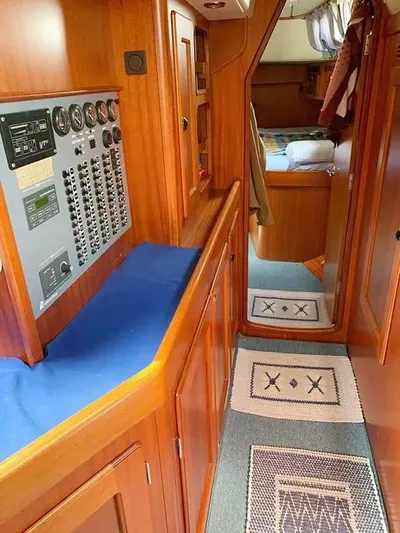  Yacht Photos Pics Interior of 2006 Hallberg-Rassy 48 MK yacht with control panel and cozy cabin.