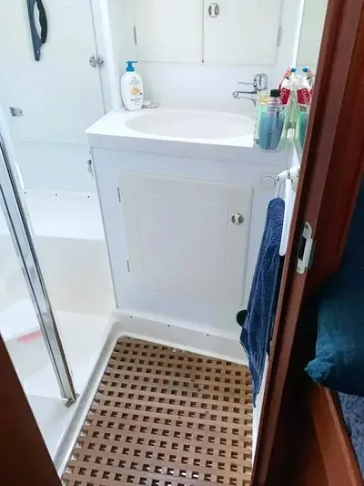  Yacht Photos Pics Bathroom interior of 2006 Hallberg-Rassy 48 MK yacht with sink and toiletries.