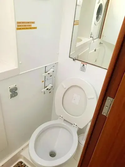  Yacht Photos Pics Bathroom interior of 2006 Hallberg-Rassy 48 MK yacht with toilet and mirror.