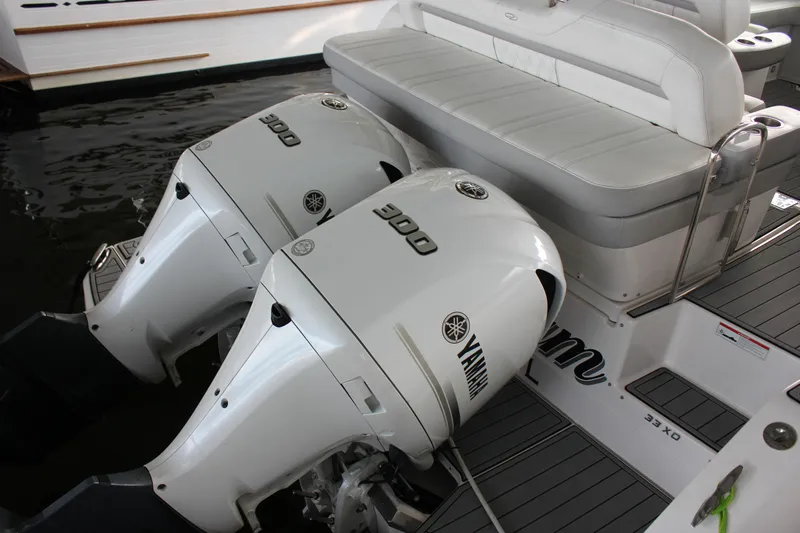  Yacht Photos Pics 2021 Regal 33 XO boat with twin Yamaha 300 engines, docked with cushioned seating.