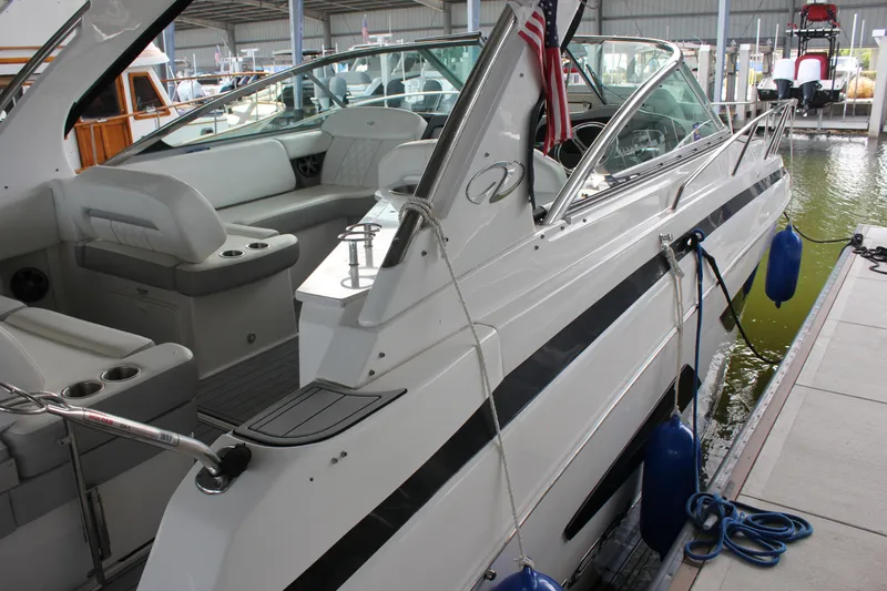  Yacht Photos Pics 2021 Regal 33 XO boat docked, featuring sleek design and spacious seating area.