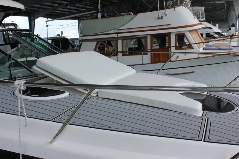  Yacht Photos Pics 2021 Regal 33 XO yacht with sunbed on deck, docked under shelter.