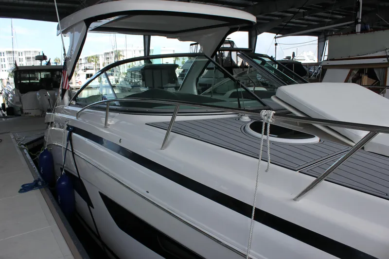  Yacht Photos Pics 2021 Regal 33 XO yacht docked in marina, sleek design, under covered area.