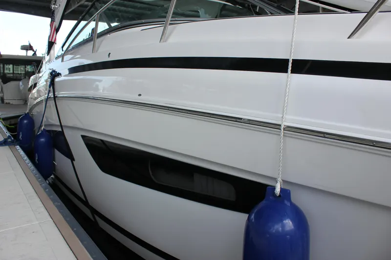  Yacht Photos Pics 2021 Regal 33 XO yacht docked with blue fenders, sleek white hull design.