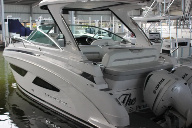  Yacht Photos Pics 2021 Regal 33 XO boat with Yamaha engines docked in a marina.