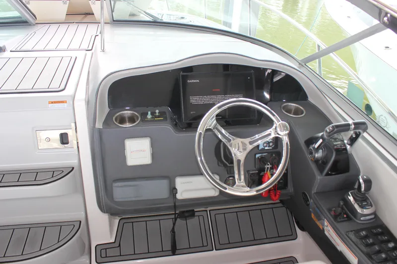  Yacht Photos Pics 2021 Regal 33 XO boat helm with steering wheel and control panel.