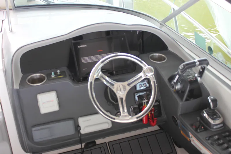  Yacht Photos Pics 2021 Regal 33 XO boat helm with steering wheel and control panel.