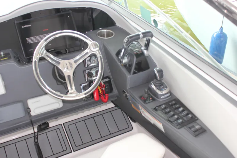  Yacht Photos Pics 2021 Regal 33 XO boat helm with steering wheel, controls, and navigation equipment.