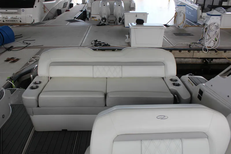  Yacht Photos Pics 2021 Regal 33 XO boat interior with white seating and cup holders at dock.