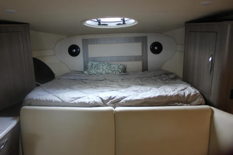  Yacht Photos Pics Interior cabin of 2021 Regal 33 XO yacht with bed and storage cabinets.