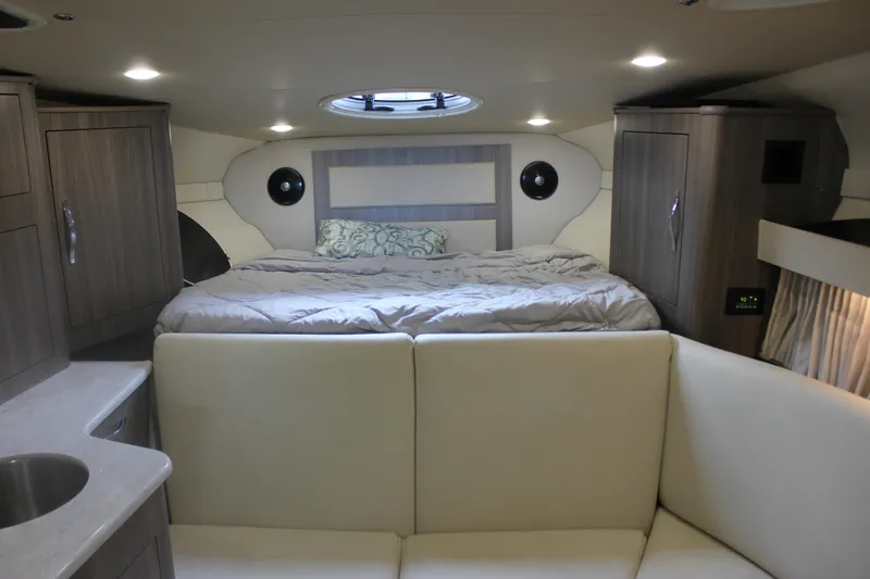  Yacht Photos Pics Interior of 2021 Regal 33 XO yacht with cozy bed and modern cabinetry.