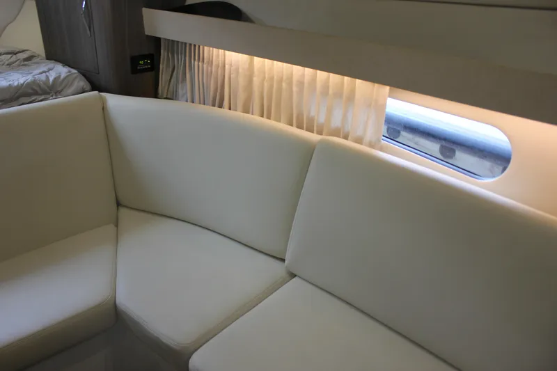  Yacht Photos Pics Interior of 2021 Regal 33 XO yacht with white seating and window view.
