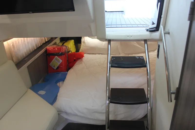  Yacht Photos Pics Interior cabin of 2021 Regal 33 XO boat with bed and ladder access.