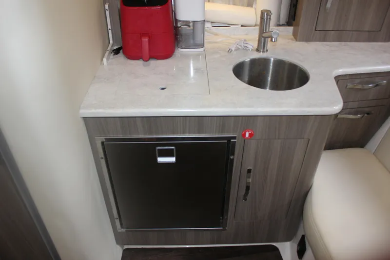  Yacht Photos Pics 2021 Regal 33 XO boat interior kitchenette with sink and countertop.