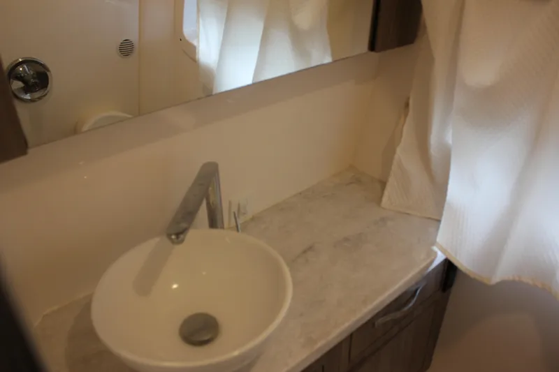  Yacht Photos Pics Modern bathroom sink in 2021 Regal 33 XO boat, featuring sleek design and marble countertop.