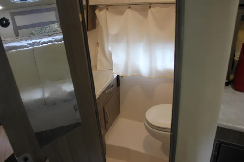  Yacht Photos Pics Interior of 2021 Regal 33 XO boat showing bathroom and bedroom area.