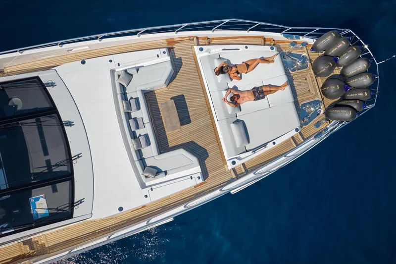 Aluminia Too Yacht Photos Pics 2024 Azimut Grande 27M yacht with sunbathing area on deck, cruising in blue waters.
