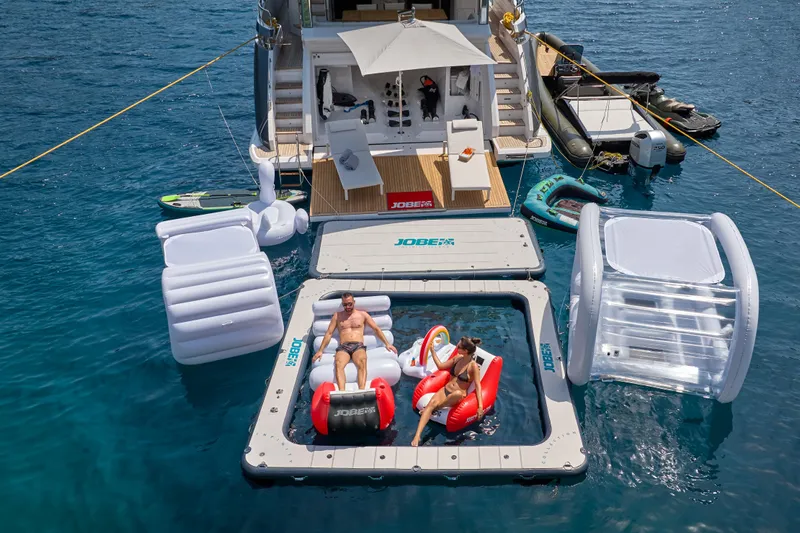 Aluminia Too Yacht Photos Pics Luxurious 2024 Azimut Grande 27M yacht with floating inflatables and sunbathing area.