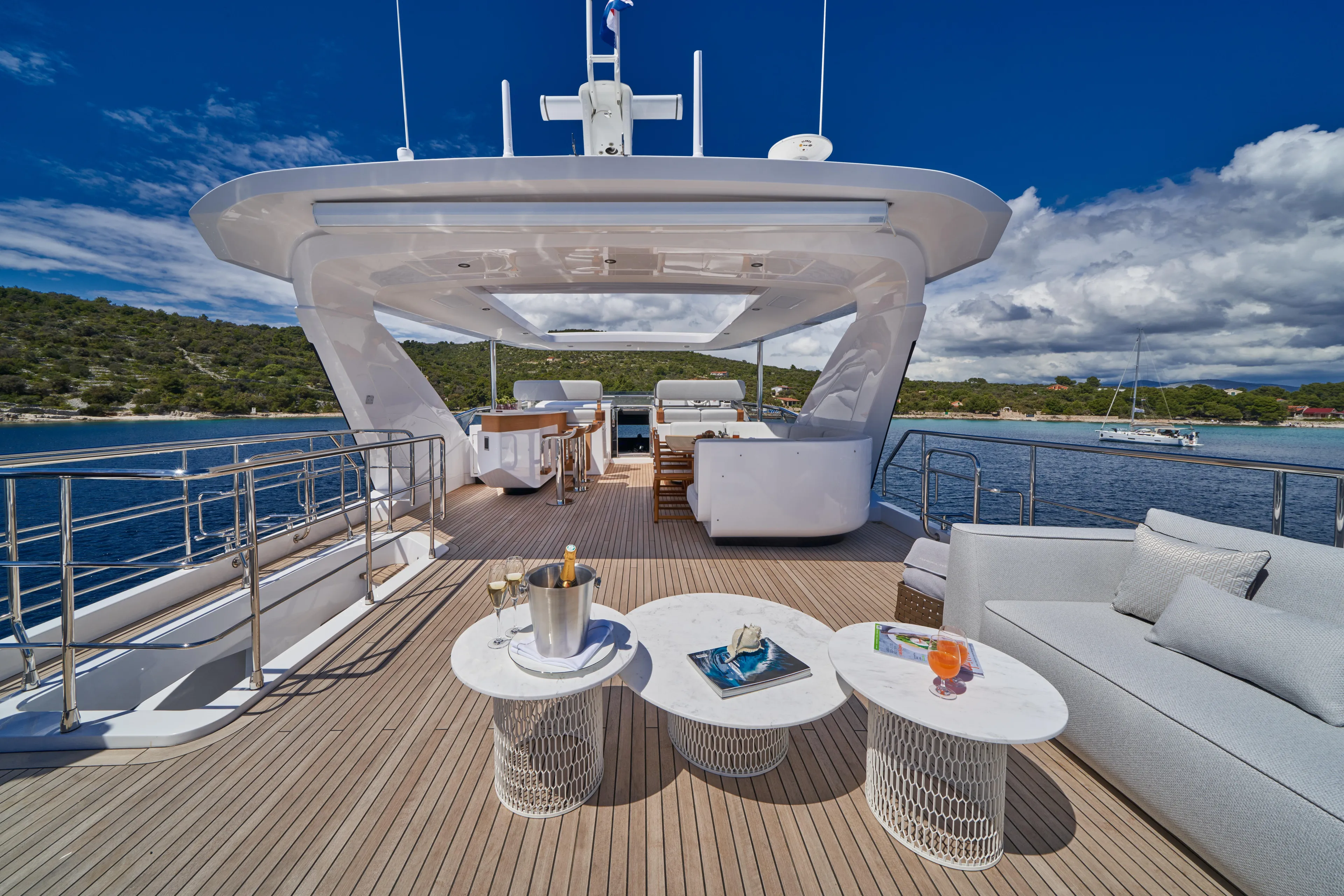 Aluminia Too Yacht Photos Pics Luxurious 2024 Azimut Grande 27M yacht deck with elegant seating and ocean view.