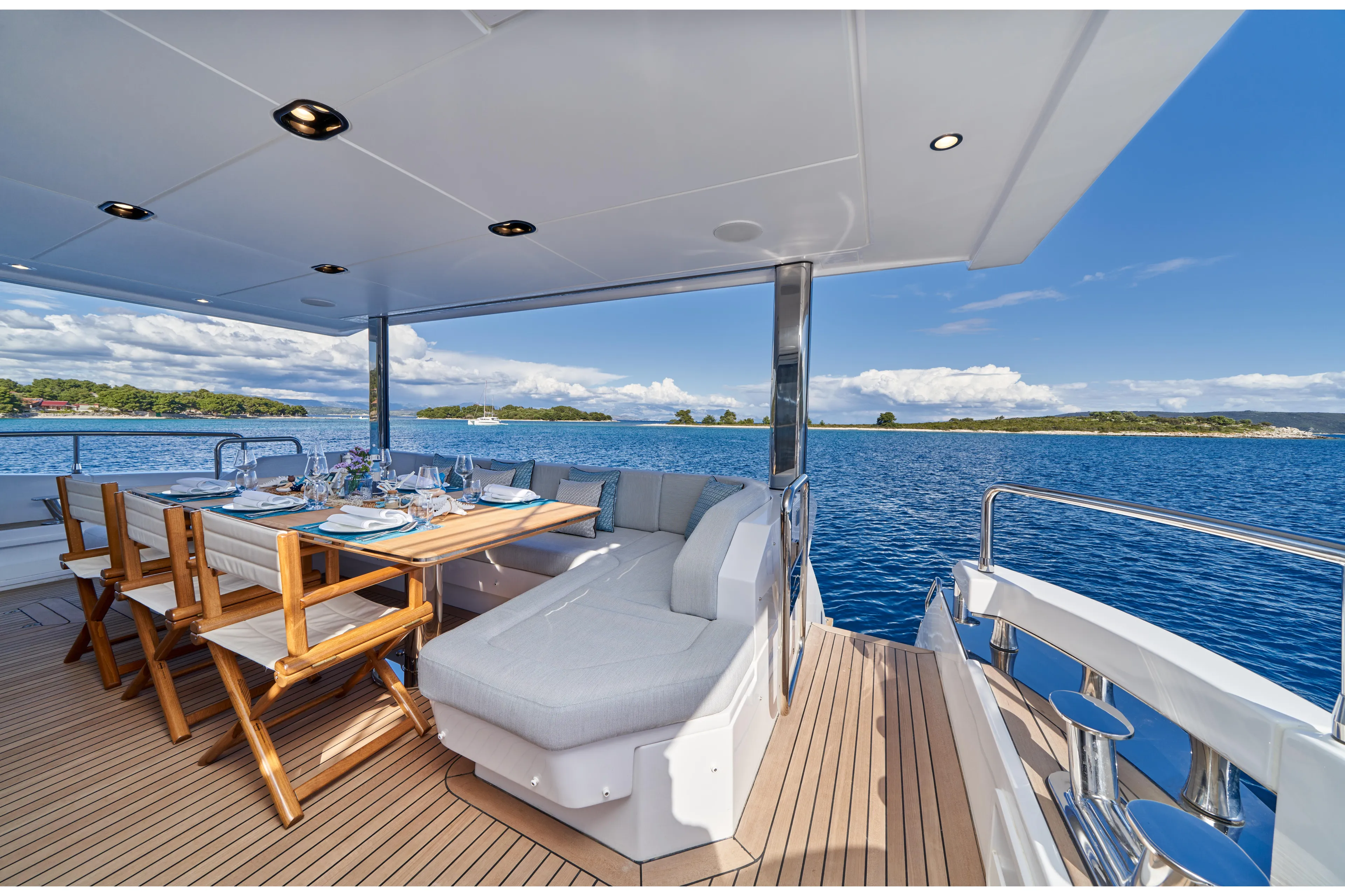 Aluminia Too Yacht Photos Pics Luxurious 2024 Azimut Grande 27M yacht deck with dining area and ocean view.