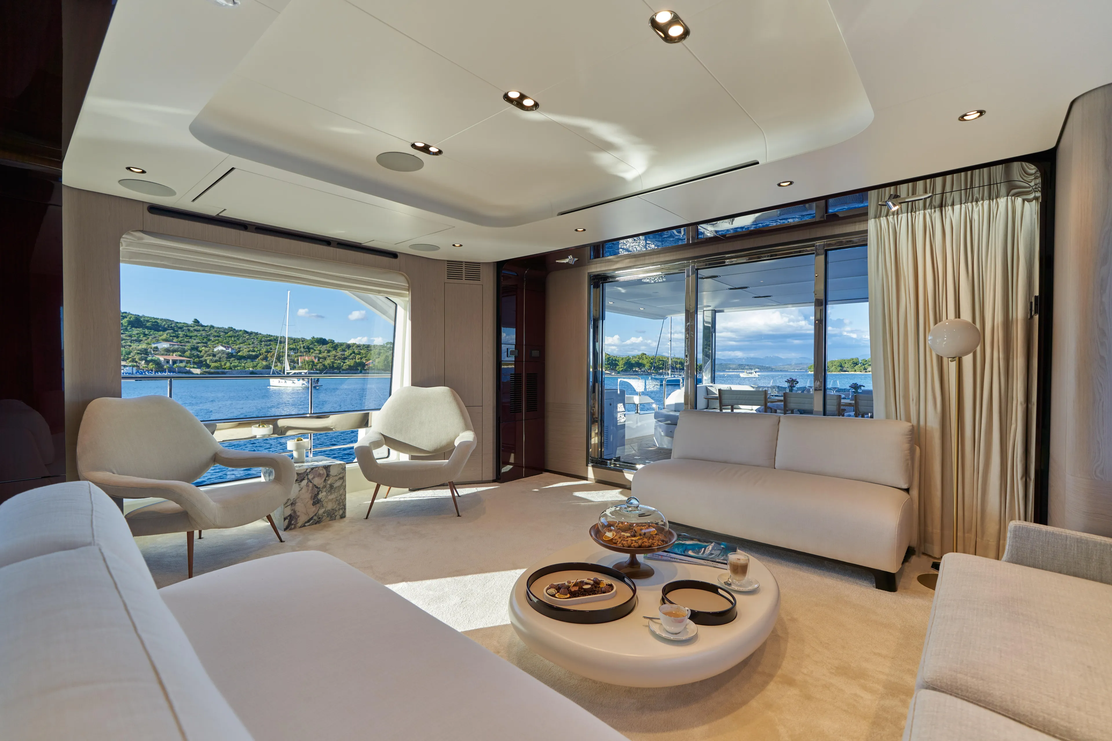 Aluminia Too Yacht Photos Pics Luxurious interior of 2024 Azimut Grande 27M yacht with elegant seating and ocean view.