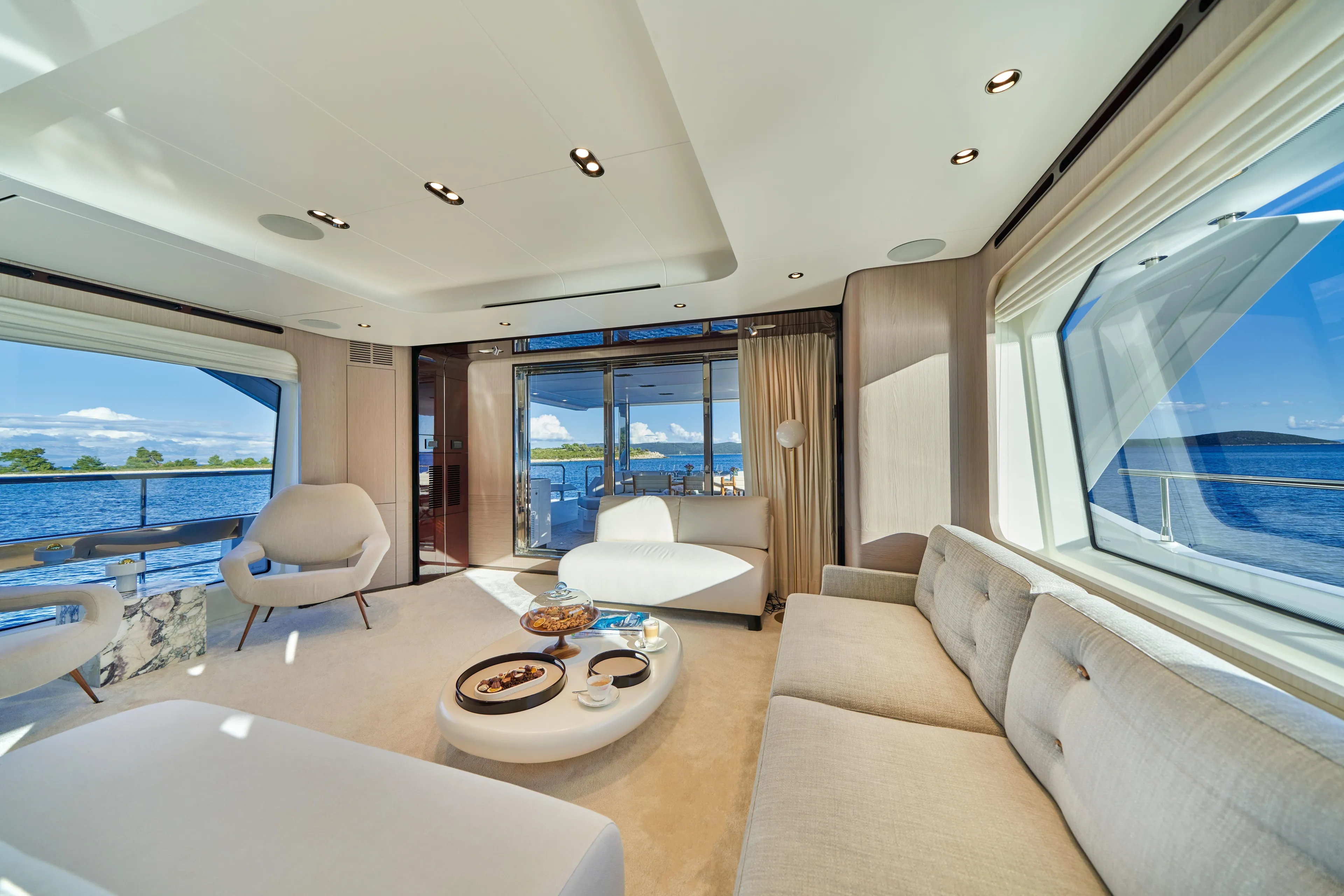 Aluminia Too Yacht Photos Pics Luxurious interior of 2024 Azimut Grande 27M yacht with elegant seating and ocean view.