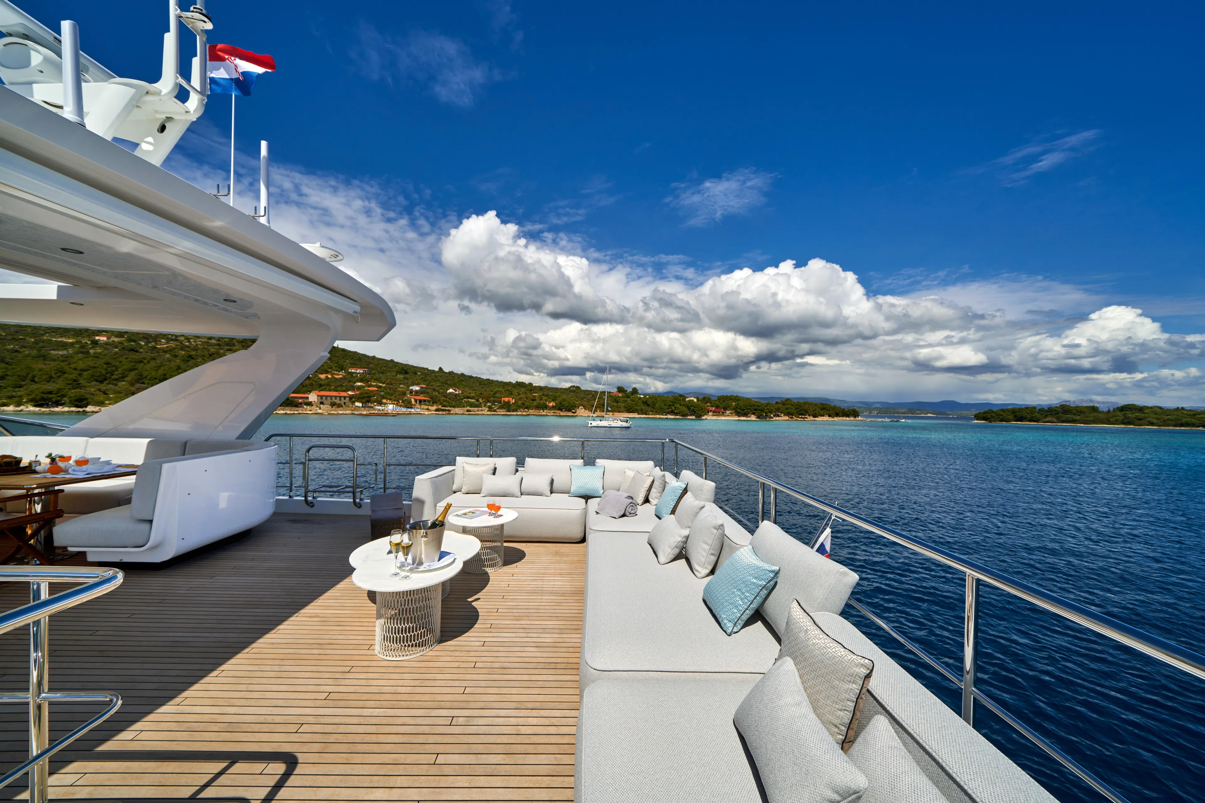 Aluminia Too Yacht Photos Pics Luxurious 2024 Azimut Grande 27M yacht deck with elegant seating and ocean view.