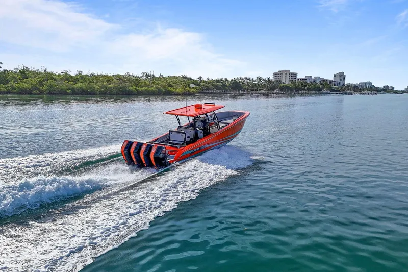  Yacht Photos Pics 2026 Nor-Tech 390 Sport Center Console cruising on a sunny day near a coastal city.