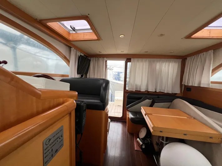  Yacht Photos Pics Interior of 2007 Cantieri Estensi Goldstar 440 yacht, featuring wood finishes and comfortable seating.