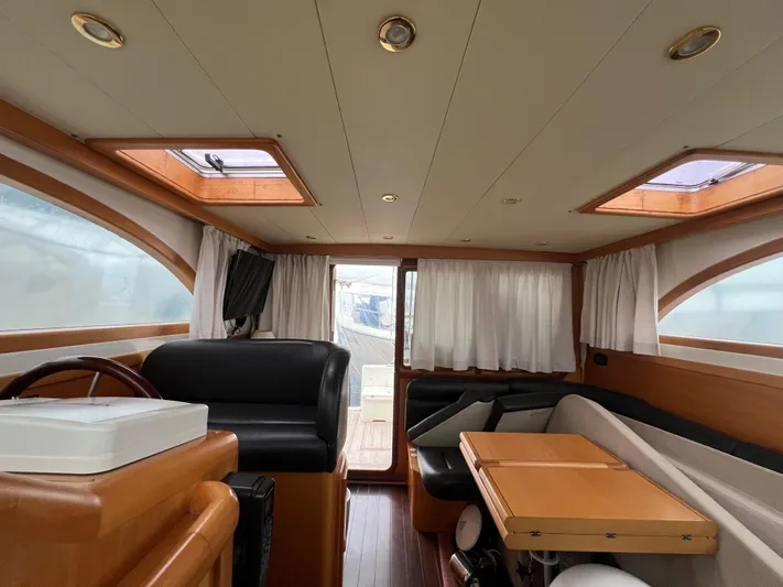  Yacht Photos Pics Interior of 2007 Cantieri Estensi Goldstar 440 yacht with wood accents and seating area.