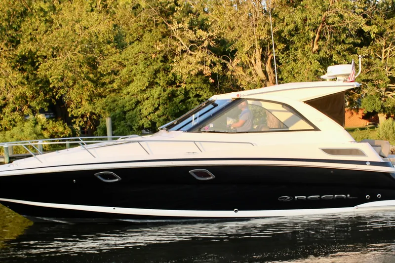 Gratitude Yacht Photos Pics 2015 Regal 35 Sport Coupe cruising on a serene waterway with lush greenery.