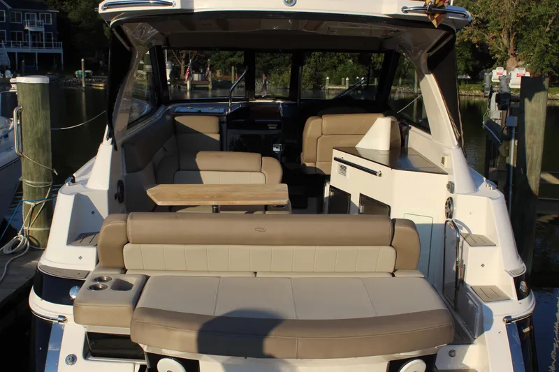 Gratitude Yacht Photos Pics 2015 Regal 35 Sport Coupe boat interior with seating and table, docked at marina.