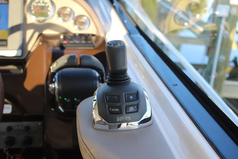 Gratitude Yacht Photos Pics Joystick control on 2015 Regal 35 Sport Coupe dashboard, featuring navigation instruments.