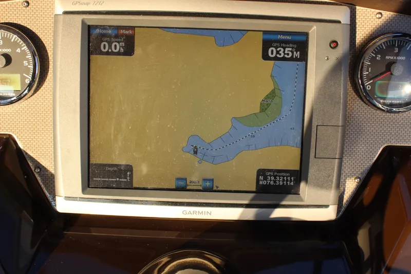 Gratitude Yacht Photos Pics Garmin GPS display on 2015 Regal 35 Sport Coupe dashboard, showing navigation map and gauges.
