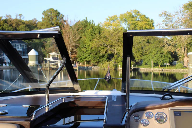 Gratitude Yacht Photos Pics 2015 Regal 35 Sport Coupe dashboard view with scenic waterfront background.