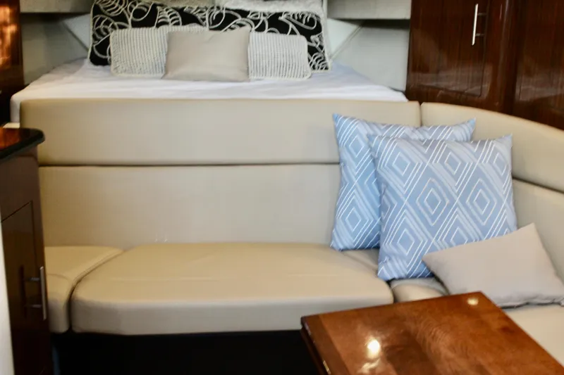 Gratitude Yacht Photos Pics Interior of 2015 Regal 35 Sport Coupe with beige seating and decorative pillows.