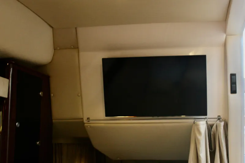 Gratitude Yacht Photos Pics Interior of 2015 Regal 35 Sport Coupe with mounted flat-screen TV.