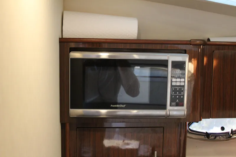 Gratitude Yacht Photos Pics Microwave in 2015 Regal 35 Sport Coupe yacht kitchen with wood cabinetry.