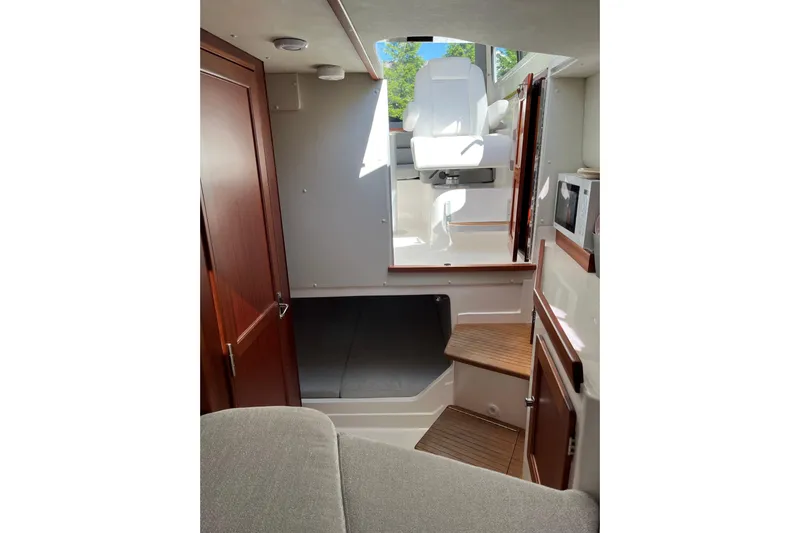  Yacht Photos Pics Interior of 2025 NorthCoast 285 HT boat with modern seating and wooden accents.