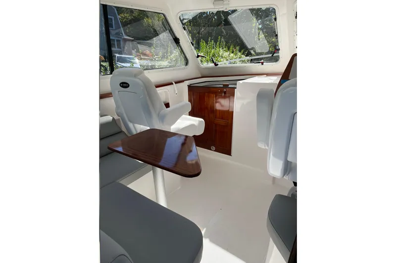  Yacht Photos Pics Interior of 2025 NorthCoast 285 HT boat with seating and wooden accents.