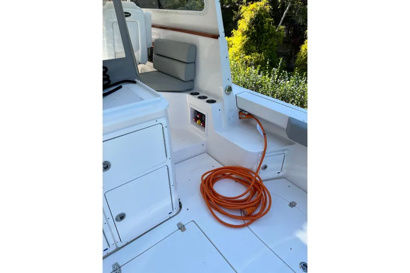  Yacht Photos Pics Interior of 2025 NorthCoast 285 HT boat with coiled orange cable and seating.