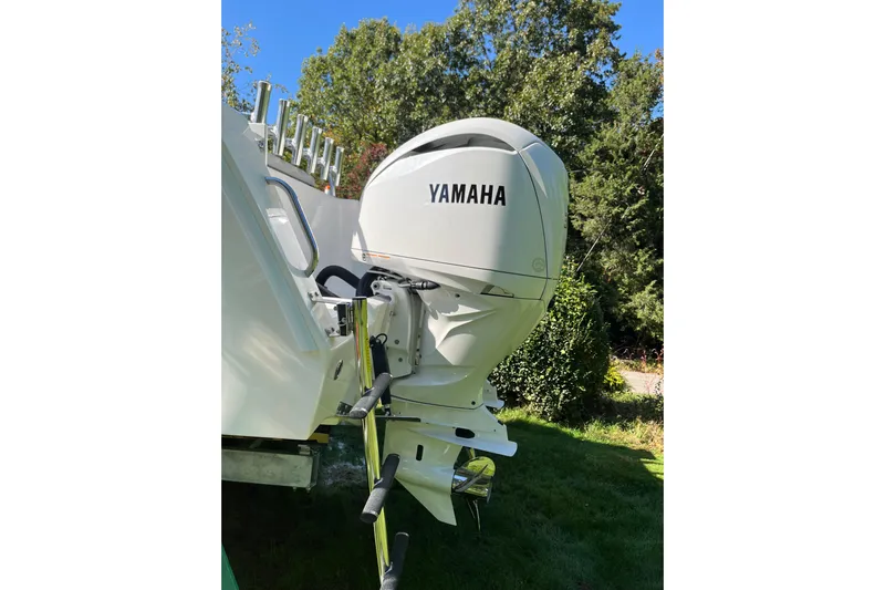  Yacht Photos Pics 2025 NorthCoast 285 HT boat with Yamaha outboard motor, set against a lush green backdrop.