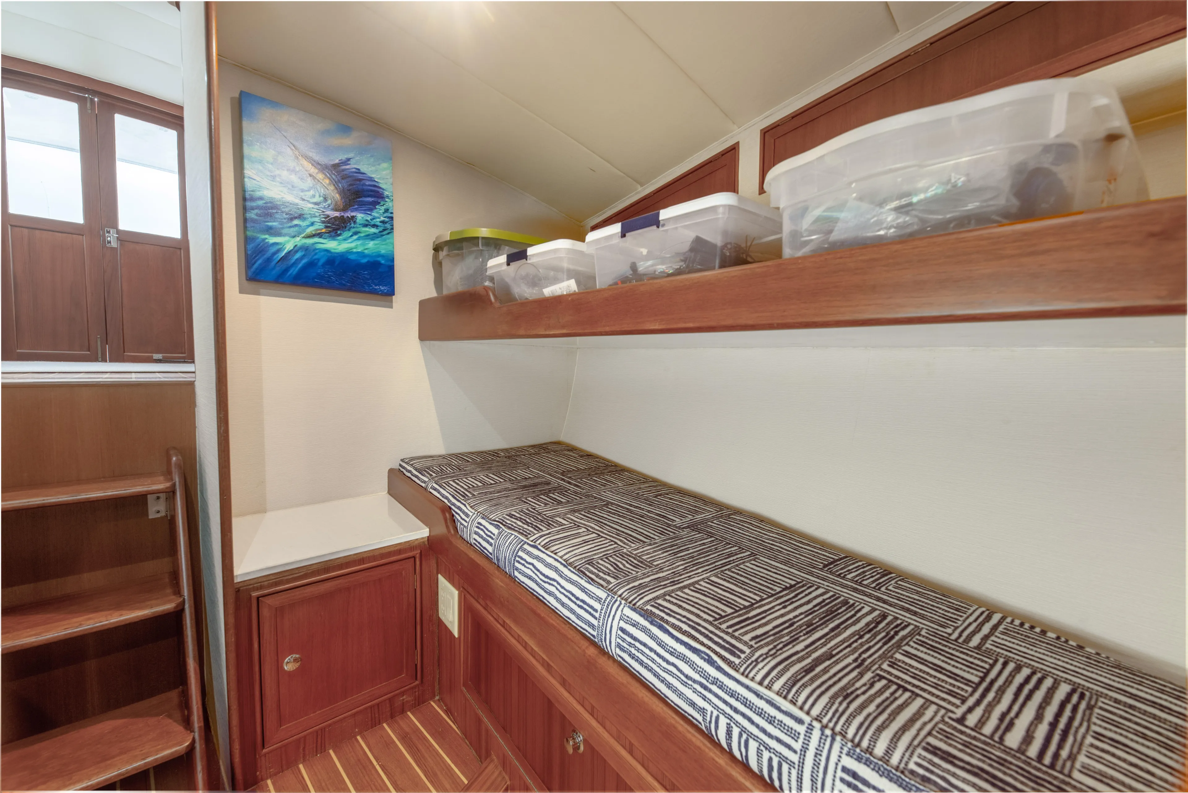 Megabite Yacht Photos Pics 1984 Custom Carolina Scarborough interior with wooden stairs, storage, and patterned bench.