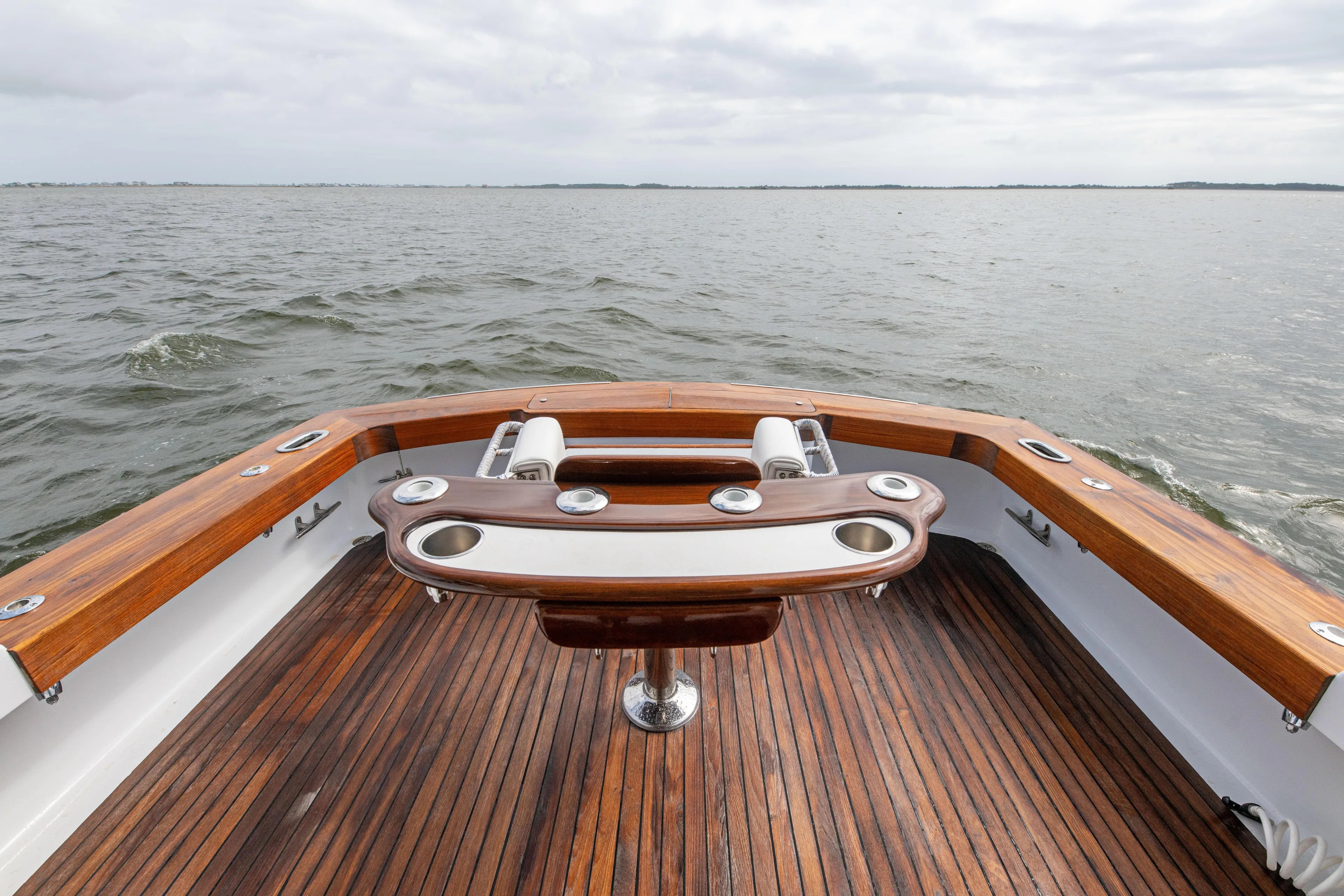Megabite Yacht Photos Pics 1984 Custom Carolina Scarborough boat with wooden deck, fishing rod holders, and ocean view.